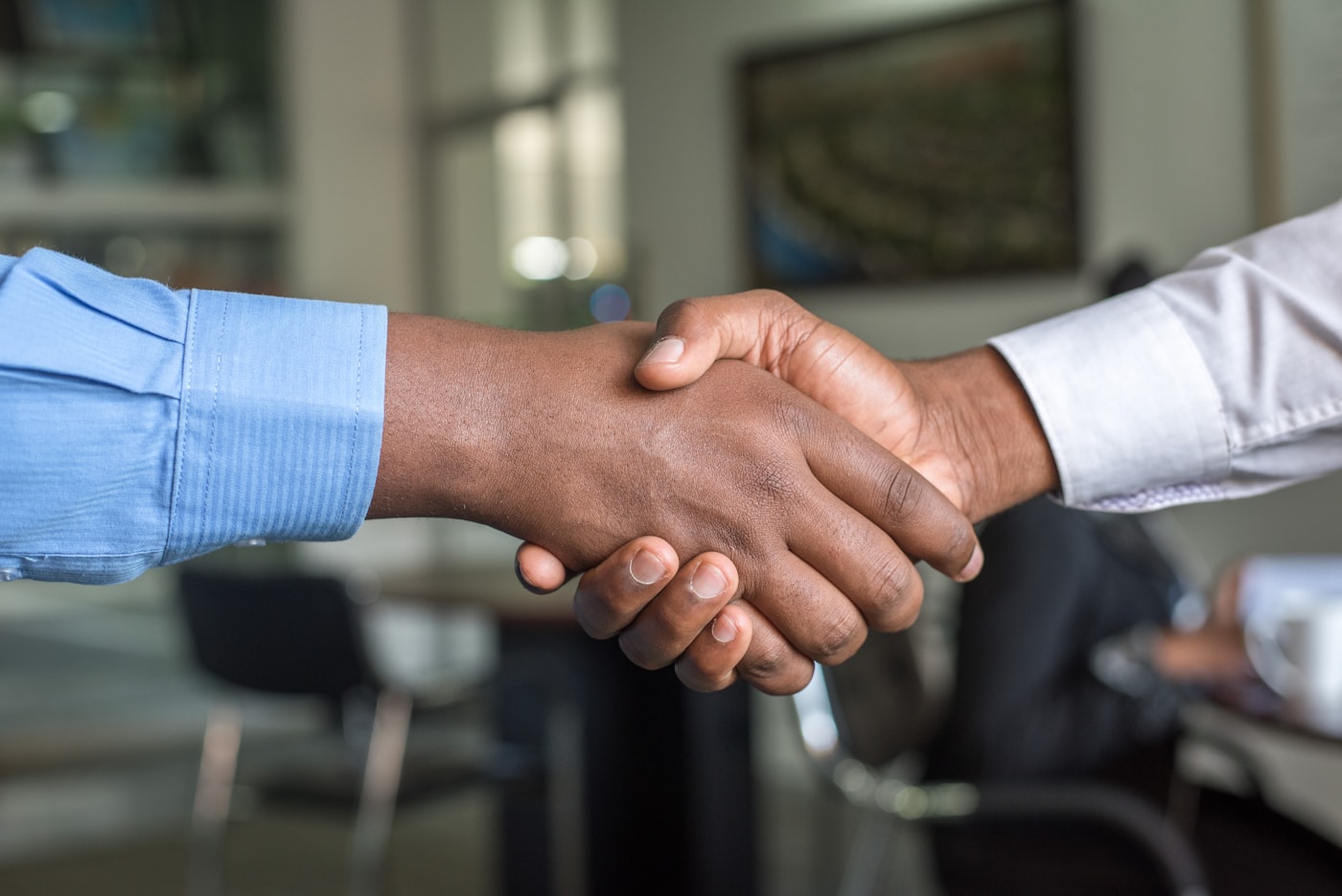 Two professionals shaking hands after a negotiation